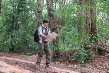 Lonely man with leather boots walking along the path strewn with a muddy road