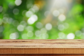 Blurred green bokeh background and wooden table.