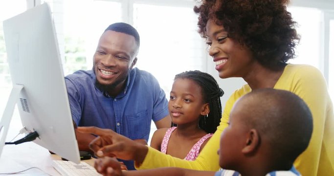 African American happy family using desktop computer