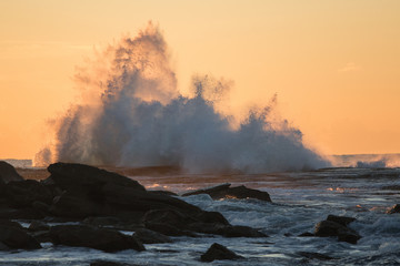 Big splash of wave after hitting rocks