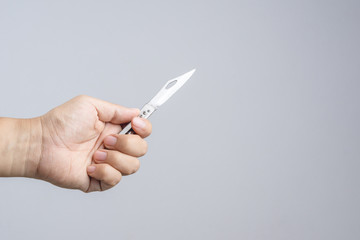 Hand holding sharp pocket fold metal knife