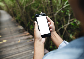 girl hold smart phone walking on road