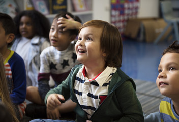 Kindergarten students sitting on the floor