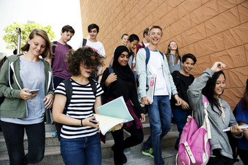 Fototapeta premium Group of school friends walking down staircase