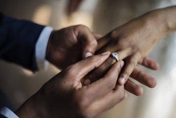 Groom Put on Wedding Ring Bride Hand - Powered by Adobe