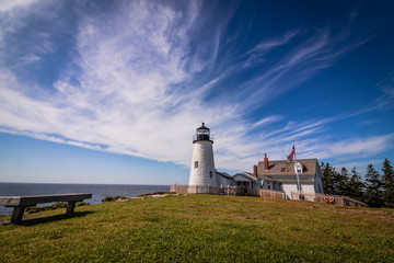Fototapeta na wymiar Pemaquid Point Lighthouse on dramatic rocky coast in Bristol, Maine, on a beautiful summer day