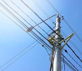 Transmission power tower electricity pylon over blue sky. Steel lattice tower used to support an overhead power line