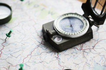 Closeup of compass on the map journey planning