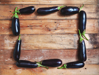 Frame of ripe blue eggplant on wooden boards