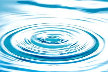 Water splashing droplets with ripples, abstract blue waves
