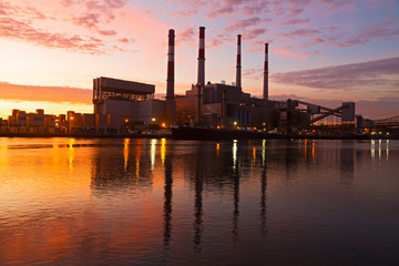 Electric Power plant at sunrise. New York city infrastructure on the shore of East River at dawn.