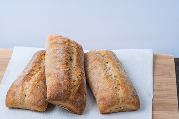 three loaves ciabatta bread on paper towel