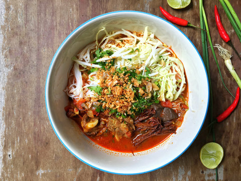 Khanom Jin Nam Ngiao, Northern Thai dish made from fermented rice noodles served with pork or chicken blood tofu in sauce made with pork broth, tomato, crushed fried dry chilies.