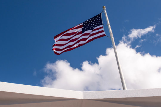 An America flag is flying in blue sky