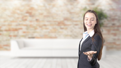 Young beautiful business woman and creative designer standing over blured interior background