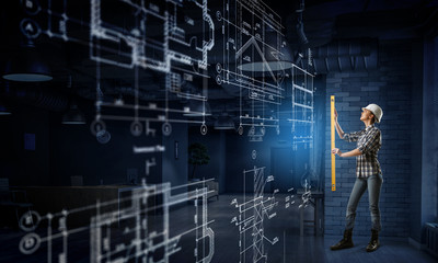 Builder woman taking measures . Mixed media