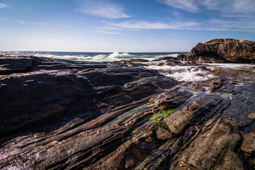 Scenic rocky shoreline in La Verna Preserve in Bristol, Maine, on a beautiful summer day