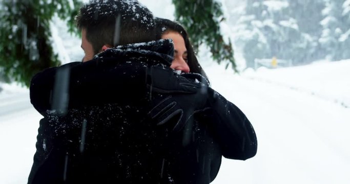 Man offering engagement ring to woman while proposing