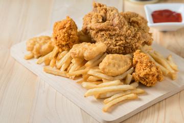 Fried chicken with nugget and french fries.