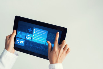 Close of female doctor hands working with tablet pc computer