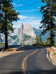 The road leading to Glacier Point in Yosemite National Park, California, USA with the Half Dome in the background. - obrazy, fototapety, plakaty