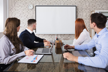 Business People Looking At White Board