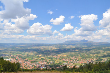 Fototapeta na wymiar Panorama of the city under a mountain with a beautiful dynamic sky. Serbian spa city Sokobanja under a Rtanj mountain