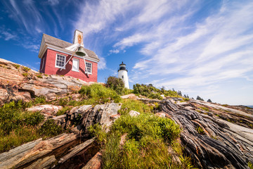 Pemaquid Point Lighthouse on dramatic rocky coast in Bristol, Maine, on a beautiful summer day