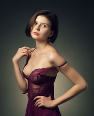 Fototapeta premium Girl posing in red negligee, underwear