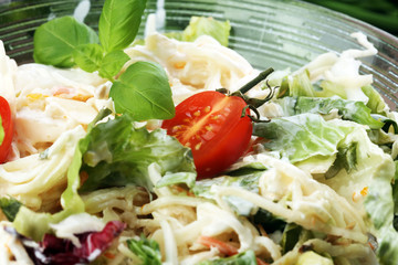 bowl of salad with vegetables and greens on wooden table