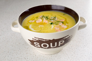 Vegetable soup puree with shrimps and lemon