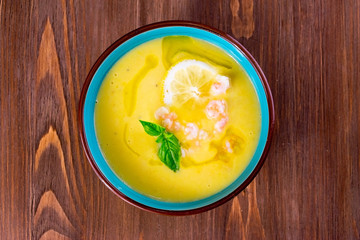 Vegetable soup puree with shrimps and lemon
