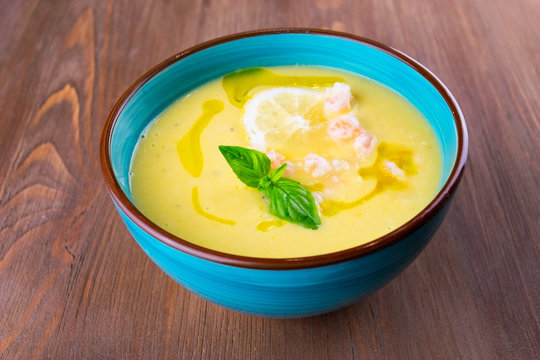 Vegetable soup puree with shrimps and lemon