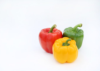 Green, red and yellow bell pepper isolated on white background.