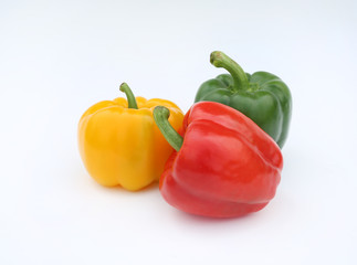 Green, red and yellow bell pepper isolated on white background.