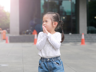 Portrait of cute little girl walking and looking out.
