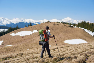 Rearview shot of a male hiker with hiking equipment walking in the mountains copyspace sportsman athlete active lifestyle nature travel freedom
