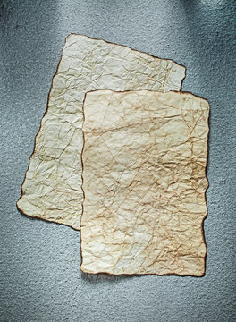 Aged sheets of paper on grey background