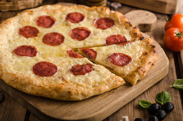 Rustic pizza with tomato, cheese, salami