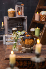 Festive cupcake with a bouquet of valley lilies on a background of candles