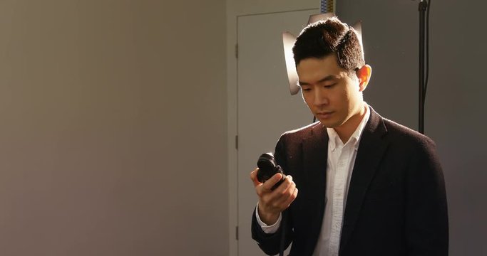 Photographer using a light meter