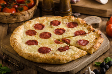 Rustic pizza with tomato, cheese, salami