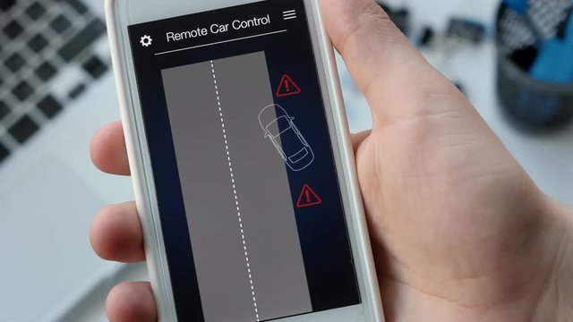 Man remotely parking his car. Car remote control using smartphone application fictional interface.