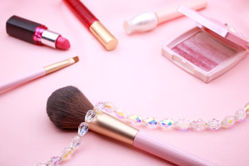 Obraz na płótnie Canvas Set of decorative cosmetics and crystal on pink background.