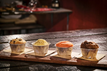 mixed freshly baked muffins in cozy coffeeshop interior