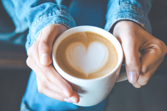 Hand And Art On Coffee In Vintage Color Filter