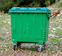  Metal green garbage can with wheels in countryside