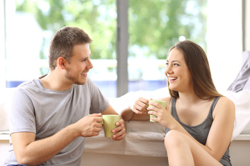 Couple talking and having breakfast in an hotel