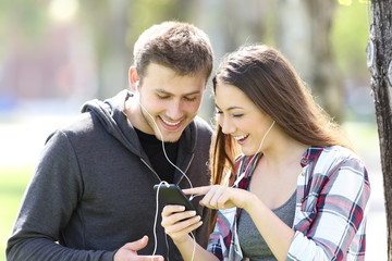 Two friends listening music and selecting song
