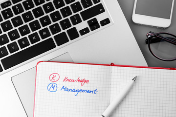 Copybook, pen and laptop on grey background. Management concept © Africa Studio